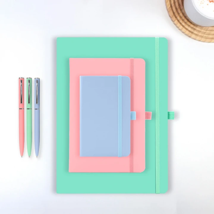 Wilson pastel notebooks in A4, A5 and A6 stacked on a white background with matching wright pastel pens